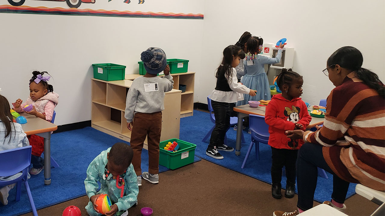 A group of children in a room with toys.